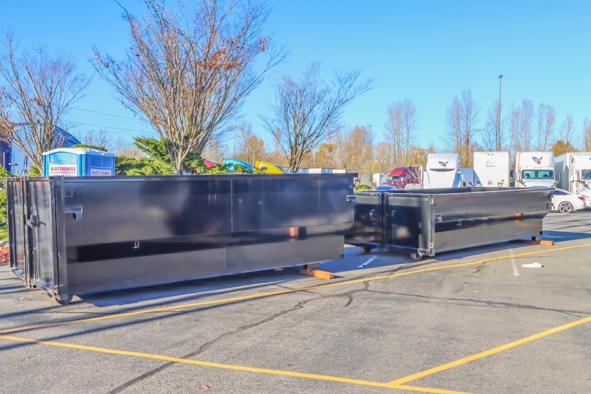 Professional dumpster rental service with roll-off container on residential driveway in Columbiana